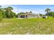Extensive backyard featuring a large lawn and a house with a screened porch at 7206 River Country Dr, Weeki Wachee, FL 34607