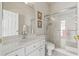 Bright bathroom featuring white vanity, framed mirror, and a glass shower with tiled accents at 7206 River Country Dr, Weeki Wachee, FL 34607
