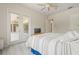 Bright primary bedroom with ceiling fan, wood-look floors, and sliding glass doors that lead to the lanai at 7206 River Country Dr, Weeki Wachee, FL 34607