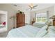 Cozy bedroom with two beds, ceiling fan, neutral color walls, and large picture window at 7206 River Country Dr, Weeki Wachee, FL 34607
