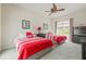 Cozy bedroom featuring two beds, a ceiling fan, and neutral walls at 7206 River Country Dr, Weeki Wachee, FL 34607