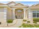 Inviting front entrance features columns, manicured shrubs, and a welcoming walkway at 7206 River Country Dr, Weeki Wachee, FL 34607