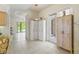 Hallway view includes storage cabinets, tile flooring, and a view of the backyard at 7206 River Country Dr, Weeki Wachee, FL 34607