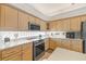Bright kitchen includes stainless steel appliances, light wood cabinets, and stone countertops at 7206 River Country Dr, Weeki Wachee, FL 34607