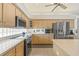 Bright kitchen features stainless appliances, light wood cabinets, and ample counter space at 7206 River Country Dr, Weeki Wachee, FL 34607