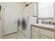 A functional laundry room featuring a washer, dryer, utility sink, and ample storage space at 7206 River Country Dr, Weeki Wachee, FL 34607