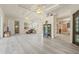 Bright living room with tray ceilings, wood floors, and display cabinet at 7206 River Country Dr, Weeki Wachee, FL 34607