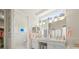 Bright main bathroom with double vanity, wall decor, toilet and walk-in closet at 7206 River Country Dr, Weeki Wachee, FL 34607
