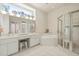 Bright main bathroom with double vanity, bathtub and glass shower, with tiled floor and walls at 7206 River Country Dr, Weeki Wachee, FL 34607