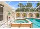 Beautiful enclosed pool area with a spa, elegant columns, and lots of space at 7206 River Country Dr, Weeki Wachee, FL 34607