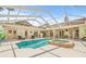 Covered pool featuring a hot tub, fireplace and ample space for entertaining or relaxation at 7206 River Country Dr, Weeki Wachee, FL 34607