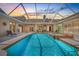Serene screened-in pool with hot tub and covered outdoor living space at dusk at 7206 River Country Dr, Weeki Wachee, FL 34607