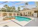 Enclosed pool area features a hot tub, lounge chairs and tile accents at 7206 River Country Dr, Weeki Wachee, FL 34607