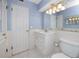 Bathroom featuring blue walls, white cabinets, and a tile floor at 7777 117Th St, Seminole, FL 33772