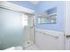 Bathroom featuring a shower with glass door, tile floor and blue walls at 7777 117Th St, Seminole, FL 33772
