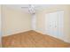 Bedroom with hardwood flooring, ceiling fan, and double door closet at 7777 117Th St, Seminole, FL 33772