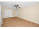 Bedroom with hardwood flooring, ceiling fan, and double door closet at 7777 117Th St, Seminole, FL 33772