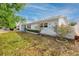 A charming home exterior is enhanced by mature landscaping, manicured flower beds, and a lush green lawn at 7777 117Th St, Seminole, FL 33772