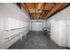 Spacious garage with exposed ceiling, shelving and storage, and a roll-up door for secure parking at 7777 117Th St, Seminole, FL 33772