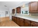 Beautiful kitchen with granite countertops, stainless steel sink, wood cabinets, and modern fixtures at 7777 117Th St, Seminole, FL 33772
