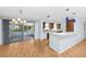 Open-concept kitchen with breakfast bar, seamlessly flowing into the dining area and sunroom at 7777 117Th St, Seminole, FL 33772