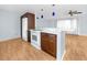 Modern kitchen with white appliances, ample storage, and light-filled dining and living area at 7777 117Th St, Seminole, FL 33772