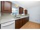 Kitchen with granite countertops, stainless steel sink, and wood cabinets at 7777 117Th St, Seminole, FL 33772