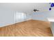 Bright living room features new wood-look floors, fan, and large window providing ample natural light at 7777 117Th St, Seminole, FL 33772