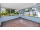Cozy screened-in porch with tile floors, perfect for enjoying the outdoors, features views of fenced backyard at 7777 117Th St, Seminole, FL 33772
