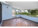 Cozy sunroom featuring mosaic tile floors and screened windows with outdoor views at 7777 117Th St, Seminole, FL 33772