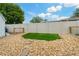 A well-maintained backyard with artificial grass, rock landscaping, and a fenced perimeter at 7909 Canna Dr, Port Richey, FL 34668