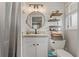 Bright bathroom with modern fixtures, shiplap walls, decorative shelves, and ample counter space at 7909 Canna Dr, Port Richey, FL 34668