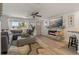 Comfortable living room with a stone fireplace, modern lighting, and stylish furnishings at 7909 Canna Dr, Port Richey, FL 34668
