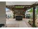 A stylish outdoor patio with a grill, tool chest, festive decorations, and cozy lighting at 7909 Canna Dr, Port Richey, FL 34668