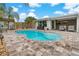 Enjoy the pool with well-maintained landscaping and an outdoor covered patio for entertainment at 7909 Canna Dr, Port Richey, FL 34668