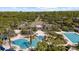 Aerial view of the community clubhouse, pools and palm trees at 8015 Hampton Glen Dr, Tampa, FL 33647
