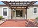 View of the back patio area with brick flooring, ceiling fan and a television at 8015 Hampton Glen Dr, Tampa, FL 33647