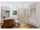 This bathroom has a glass enclosed shower, a vanity and wood-look flooring at 8015 Hampton Glen Dr, Tampa, FL 33647