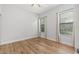 This bedroom features hardwood floors, base molding, two windows and a ceiling fan at 8015 Hampton Glen Dr, Tampa, FL 33647
