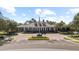 Community clubhouse with brick drive and an American flag at 8015 Hampton Glen Dr, Tampa, FL 33647