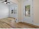 View of the light-filled entryway featuring wood-look floors, an office and the front door at 8015 Hampton Glen Dr, Tampa, FL 33647