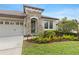 Close up of the entrance, beautiful landscaping and a three-car garage at 8015 Hampton Glen Dr, Tampa, FL 33647