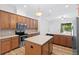 Open-concept kitchen with a large center island, stainless steel appliances, and ample storage at 8015 Hampton Glen Dr, Tampa, FL 33647