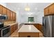 Well-equipped kitchen with stainless steel appliances, island, and open layout to the living area at 8015 Hampton Glen Dr, Tampa, FL 33647