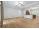 Spacious living room boasts hardwood floors and lots of natural light from the adjacent kitchen area at 8015 Hampton Glen Dr, Tampa, FL 33647
