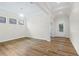 Sun-filled living room showcasing wood flooring and access to the main entryway at 8015 Hampton Glen Dr, Tampa, FL 33647