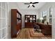 Office space featuring wooden floors, book cases, an executive desk and french doors at 8015 Hampton Glen Dr, Tampa, FL 33647