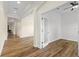 An office space with wood floors, white walls, and a door to the entry hallway at 8015 Hampton Glen Dr, Tampa, FL 33647