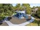 Community playground with blue slides and sunshade, creating a fun and protected play area for children at 8015 Hampton Glen Dr, Tampa, FL 33647