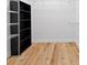 A walk-in closet features custom shelving and wood flooring at 8015 Hampton Glen Dr, Tampa, FL 33647